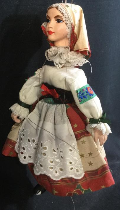 Antique Folk Women Figural Puppet: European Farmer’s Girl With Folk Regalia. Possibly antique. Material has Christmas decor of red bows, gold stars and holly. Painted Ceramic face, hands & boots. Paint chips on boots. Not all puppet