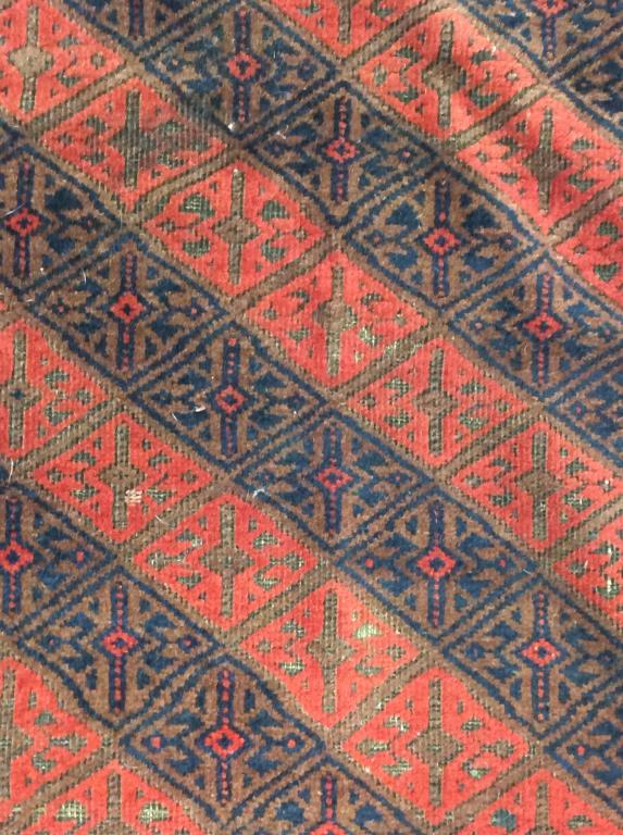 Handmade Afghan Geometrically Detailed Wool Rug: Rug is wool & handmade. Contains geometric detail with tones of red, navy & chocolate. Measures approx 42 inches wide 74 inches long. Rug is vintage possibly antique. Piece has evident wear and tear o