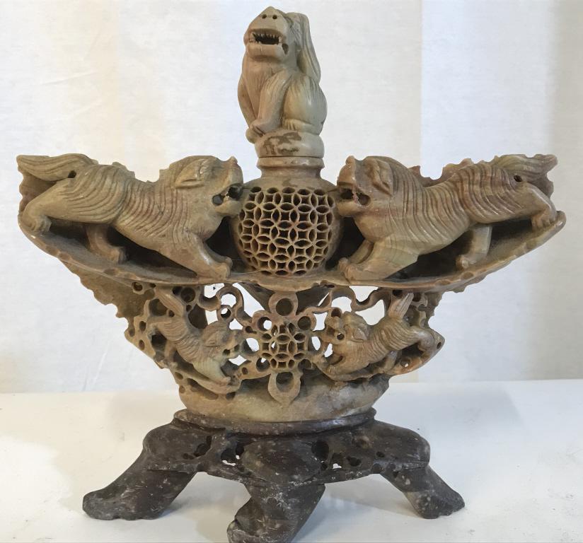 Asian Hand-carved Soapstone Foo Dog Incense Burner: Hand-carved Stone incense burner, possibly soapstone, Features foo dogs throughout along with foo dog stopper. Two tones in soapstone. Measures approx 9.5 inches in height by 10 inches in width by 3 i