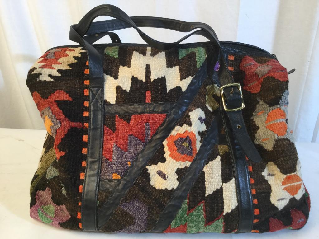 JOAN DAVID Kilim Style Tapestry Carry All Bag: Kilim Style tapestry duffel bag. Label on interior reads JOAN DAVID. Piece contains tones of red, cream, brown, orange, & green. Piece measures approx 21 inches long 13 inches deep, 24 inches tall. ki