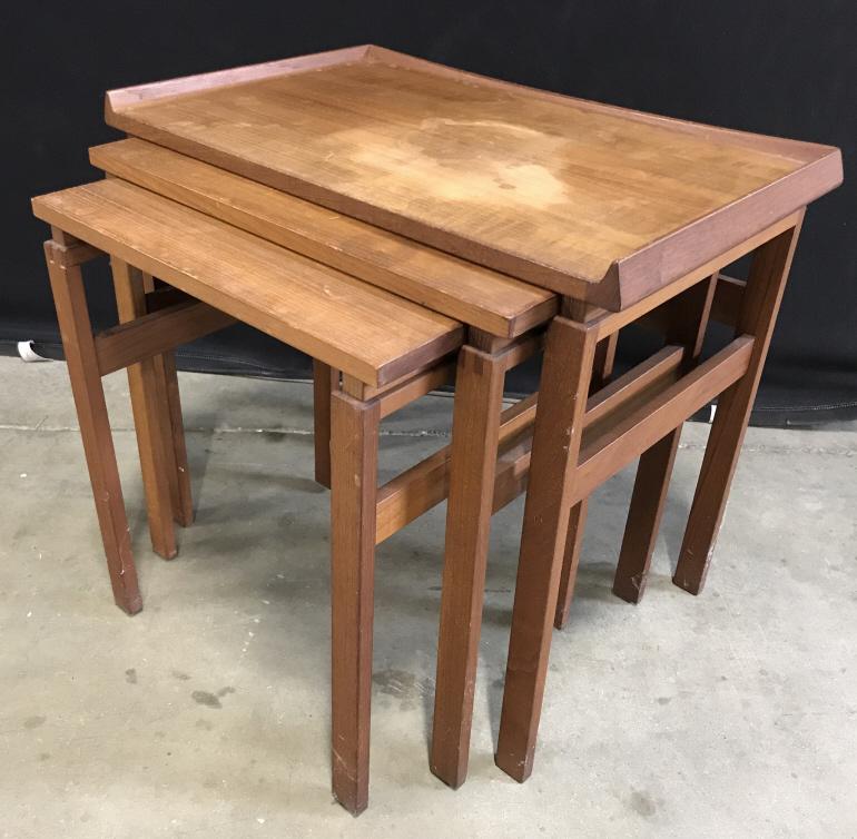 Danish Moreddi Teak Nest Of Tables Mid Century: Mid Century Danish Moreddi Teak Nest Of Tables. Set of three teak nesting tables, made in Denmark circa 1960s and imported and stamped Moreddi. They have excellent design details such as finger joints