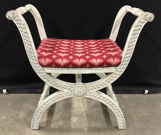 Vintage Carved X Bench X Frame Stool: Vintage Carved Wooden X Frame Stool with cream toned painted finish and upholstered seat surrounded by nailhead trim, some chips and wear to painted finish, some nailhead missing, measures approximate