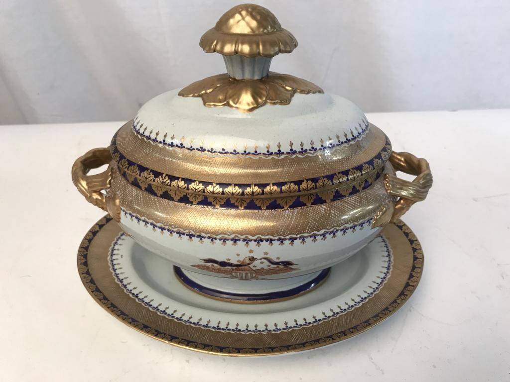 Mottahedeh Lowestoft Porcelain Tureen & Underplate: Mottahedeh Lowestoft Reproduction Porcelain Covered Tureen with Lid and Underplate. Pale blue tone with gold tone patterned rims. Both sides of the bowl and the center of the underplate are decorated 