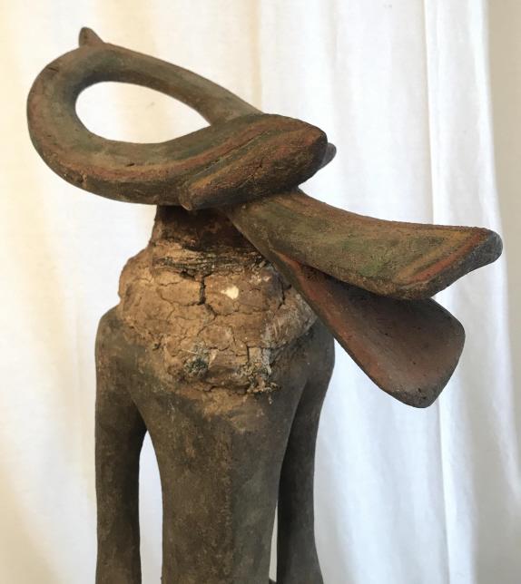 African Art Chamba Tribe Carved Bush Cow Statue: Carved wooden figural statue from the Chamba people in Nigeria. Statue features male figure with the head of a bush cow, meant to symbolize spirit, power. Figure appears to have textile with thick coa