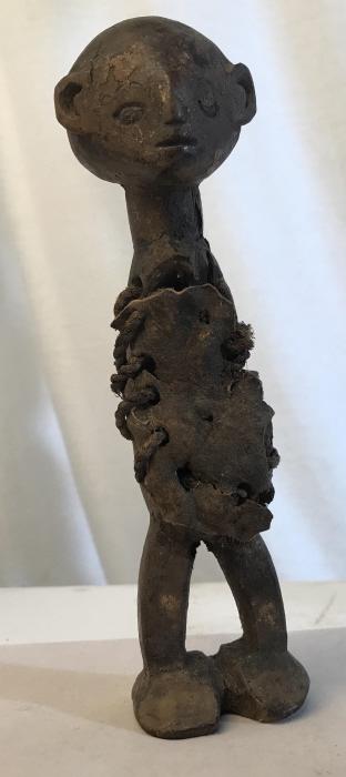 African Art Hand-Size Makonde Tribe Fetish Doll: Small-scale Carved wooden fetish statue from the Makonde People in Tanzania. Fetishes (from the Portuguese word feitio, meaning artificial, or false), ‘an inanimate object worshiped for its supposed