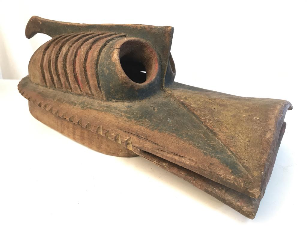 African Art Mumuye Tribe Zoomorphic Vabo Mask: Zoomorphic Vabo mask from the Mumuye people in Nigeria. Mask is carved wood with painted red, yellow, dark green details. Mask is stylized as animal with open mouth and oversized eyes. Mask measures a