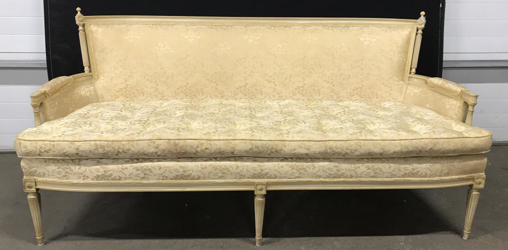 Vintage Carved French Louis Style Sofa: Vintage French Louis Style Settee Sofa With Turned Fluted Legs, Carved Frame with Side finials, painted finish and double wetted upholstered body, single tufted seat cushion, damage to one finial, sta