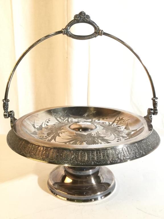 MERIDEN Quadruple Plated Pedestaled Dish: Dish is Pedestaled. Underside is marked MERIDEN COMPANY QUADRUPLE PLATED. Piece is silver toned. Contains floral, leaf and bird relief detail. Piece includes handle. Vintage Silver Tableware, possibly
