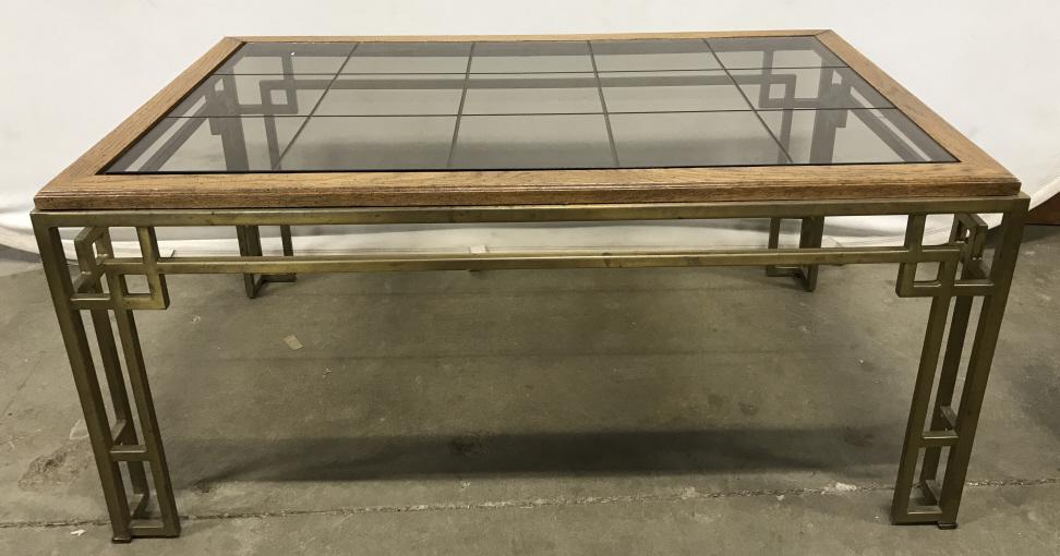 Vintage Gilt Metal Wood And Glass Low Table: Vintage Gilt Metal Wood And Glass Low Table, gold toned metal base with open work geometric design and wood framed grey tinted glass top. Some surface nicks and scratches, measures approximately 36 in