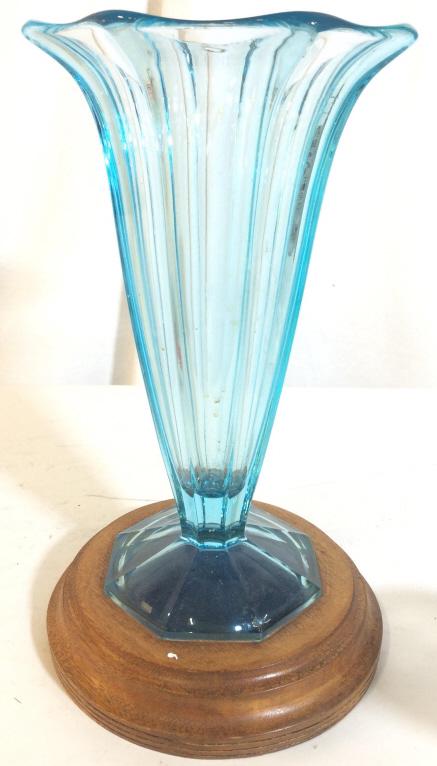 Vintage Art Glass Vase On Wooden Base: Vase is vintage. Appears to be Circa 1930’s. Piece has an aqua blue tone and light brown toned circular wooden base. art glass, vase vessel, tableware shelf piece arts and crafts, decorative accesso