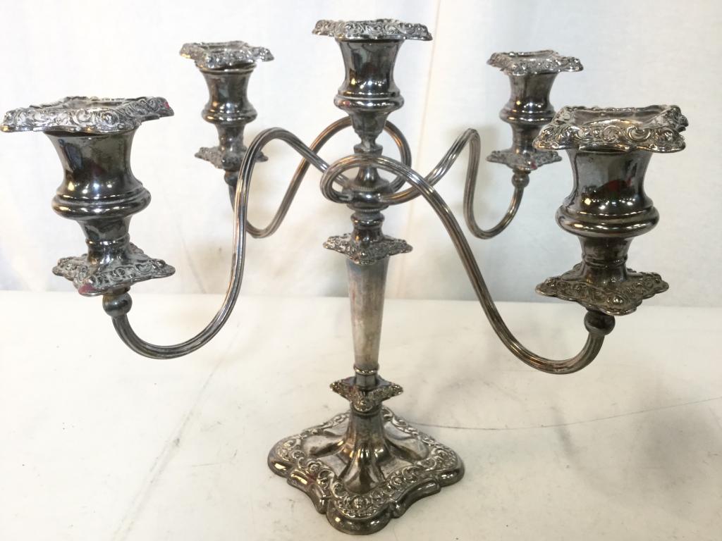 Silver Plated 4 Arm Candelabra: Piece is marked SUPERIOR SILVER CO On underside. Candelabra has 4 arms. Piece is quadruple plated. Measures approx 12 inches tall 15 inches wide. Piece contains ornate detail. Each arm has s curve det