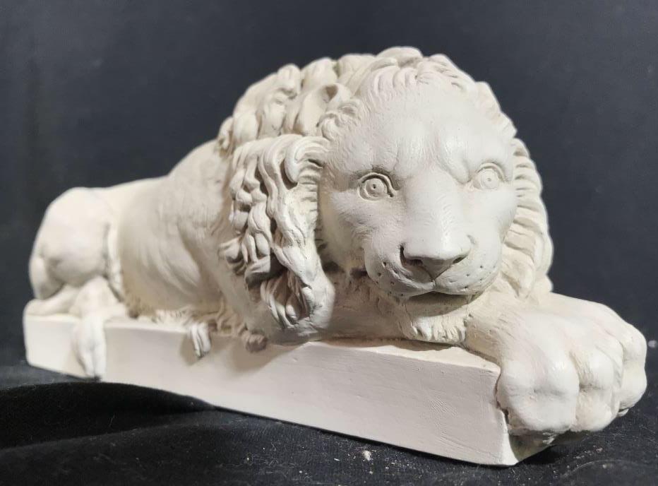Lot 2 FACSIMILES LTD. Carved Plaster Lion Figurals: Lot includes 2 cream toned Lion Figurals. Piece appear to be plaster, possibly ceramic. Each depicts a crouching Lion. Tag on each reads FACSIMILES LTD. each measures approx 8.5 inches long 3.5 inches