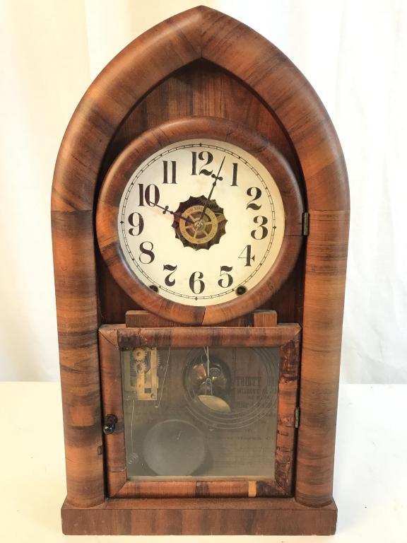 Vintage NEW HAVEN Wooden Mantel Clock: Interior of clock reads NEW HAVEN. Piece is wooden. Contains black toned hands and black toned numerical digits. Piece has windowed door. Clock is vintage possibly antique. Clock measures approx 18.5