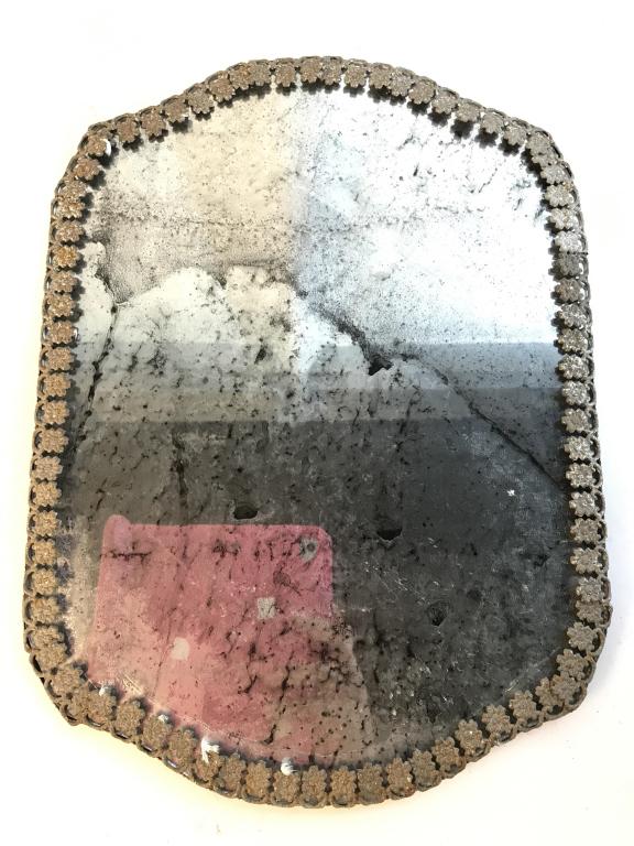 Antique Wall Mirror W Foxing: Mirror frame has floral detailed metal edge. Mirrored surface has foxing. Piece measures approx 16 inches tall 12 inches wide. Antique mirror, wall mirror, foxes mirror, mirror with foxing, antique wa