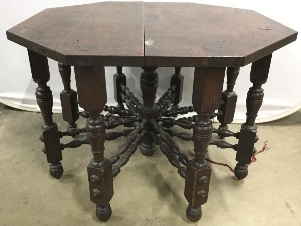 Antique Hand Crafted Carved Wooden Table: Table is antique and has handcrafted elements. Table has 8 legs and is octagonal Shaped. Table is chocolate toned. Antique table, wooden table, vintage table, handcrafted table, handmade table, handcr