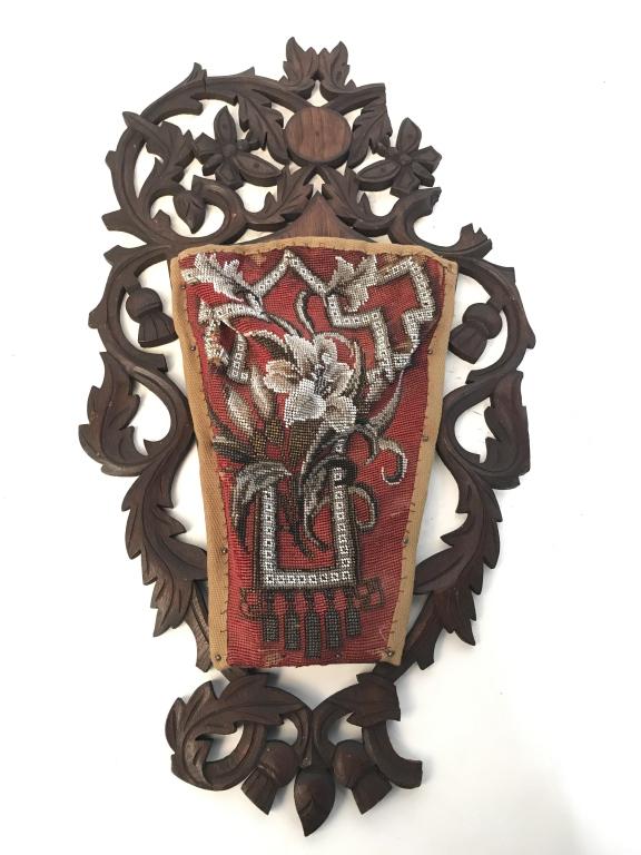 Antique Beaded Fabric on Carved Black Forest Wood: Antique beaded Fabric On Carved Black Forest wood Wall Pocket. Black Forest wood is carved with pierced scrolled leaf foliate design. Verso has etched numbers ‘262’ and symbol. Measures approx 24 