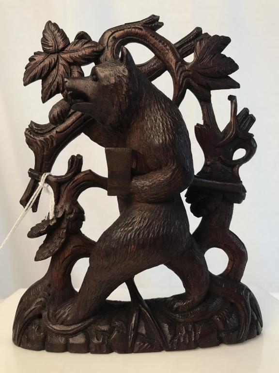Antique Black Forest Carved Wood Bear Figural: Antique Black Forest Carved Wooden bear with ax, originally for use of book end. Carved bear is walking upright with ax in hand (paw) against leaves and branches. Measures approx 7 inches in height by