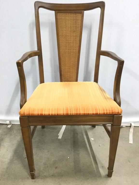 MCM BASSET CHAIR CO End Chair: Underside has label which reads BASSET CHAIR CO. Mid Century Modern chair. Chair is wooden with Caned backrest. End chair has orange toned upholstery on Seat. Piece measures approx 38 inches tall 23 i