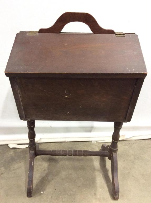Vintage Wooden Sewing Kit Holder / sewing stand: Sewing kit holder is brown toned & wooden. Contains 2 flip up openings. Top center of piece has wooden handle. Piece measures approx 29 inches tall 16.5 inches wide, 14 inches deep. end table, side ta
