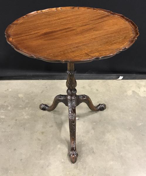 Vintage Carved Wooden Tilt Topped Table: Vintage Possibly Antique Wooden Tilt Topped Table with pie crust edge and claw footed carved tripod base, measures approximately 21 inches in diameter x 24.5 inches tall, light surface scratches to to
