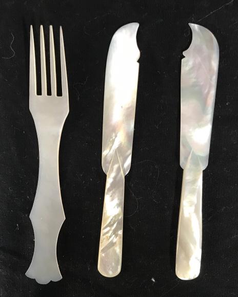 Mother of Pearl Cocktail Cutlery, Lot 3: Two butter, spread knives and one four prong fork. Cocktail size. All measure Approximately 5 in long. One knife has a sharp curved edge, the other a softer curved edge. Mother of Pearl, Mother Of Pea