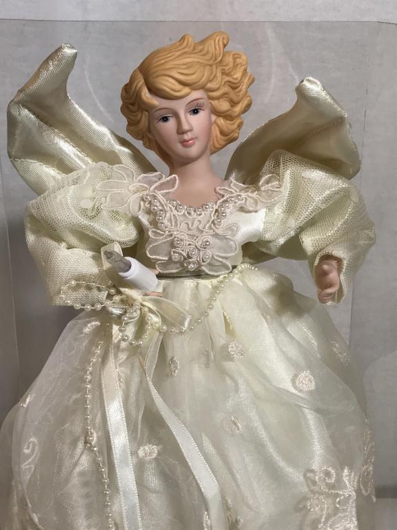 Porcelain Angel Lighted Tree Topper, Table Decor: In original Box. Angel in White Dress. Dress embroidered, has some fashion pearl decor. Lighting on bottom and one light in angel hand. Tested, not currently working. Wire plug 6 ft. Angle height 14 i