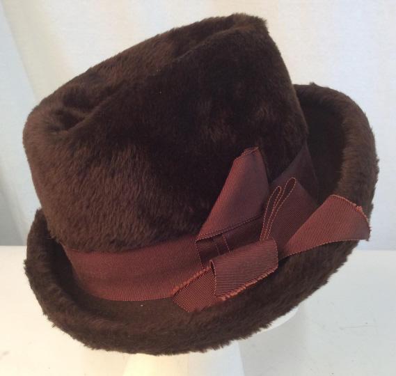 Vintage MR.JOHN CLASSIC BROWN PLUSH HAT: Mr.John brown plush hat in classic style. Brown ribbon with bow. Inside label reads NEW YORK PARIS Mr.John Classic. Rim of hat folds up. Hat has vintage wear. Vintage hat, hat, brown hat, plush hat, v