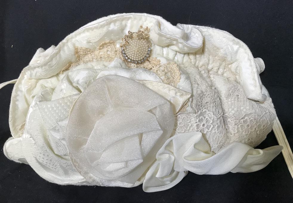 Vintage Beryl J Maddalena Shoulder Bag: Vintage Beryl J Maddalena Shoulder Bag Constructed of various cream toned materials and laces with decorative gold toned metal, pearlescent beads and rhinestone pin. Discoloration on reverse and small