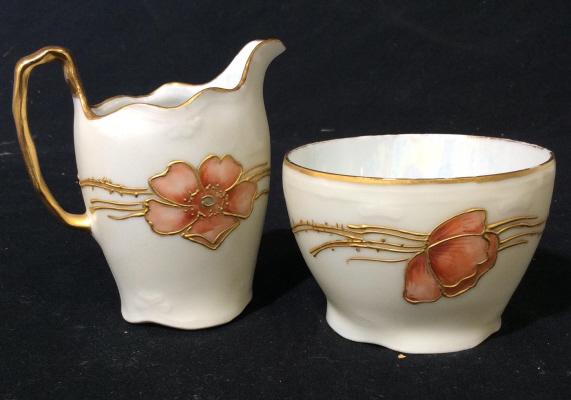 Vintage iridescent porcelain creamer & sugar: Raised gold colored detail. Iridescent inside. Gold coloring is chipping in some parts. Creamer is approximately 3 inches tall. Sugar is approximately 1.5 inches tall. Brand/artist unknown. Porcelain,