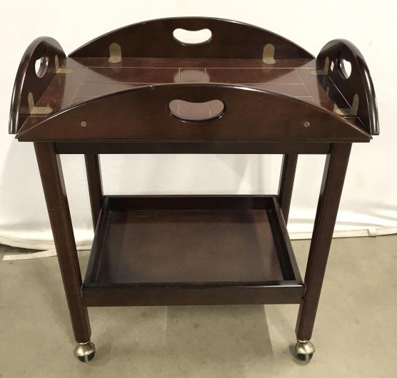 Bombay Company Tall Butlers Table On Casters: Bombay Company Tall Butlers Table On Casters, in dark toned wooden finish and brass toned metal hardware, marked on underside with Bombay Company Tag, measures approximately 35 inches long x 25 inches