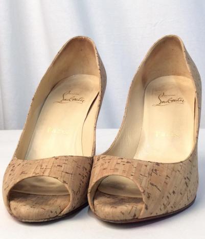 CHRISTIAN LOUBOUTIN Cork Daffodile Heels: Possibly vintage Christian Louboutin Cork daffodile peephole high heel shoes. Tan leather interior with Trademark blood red soles. EU women’s size 36.5, US women’s size 5.5. Heels are stamped on r