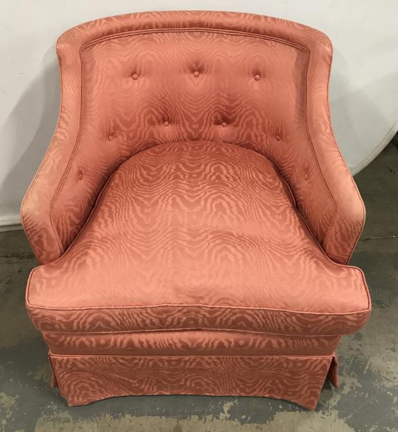 Salmon Toned Upholstered Arm Chair: Salmon Toned Upholstered Arm Chair. Upholstered fabric has zebra like pattern, double welting, slightly Tufted back, and matching throw pillow, some fading and wear arms and edges, Mark to skirt, meas