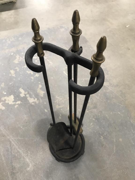 Metal Fireplace Tools W Stand: Tools include scoop, brush, and poker. Possibly iron with black tone finish. Tools have brass ends. Stand measures approx 25.5 inches in height by 7 inches in width. Stand and tools have some discolor