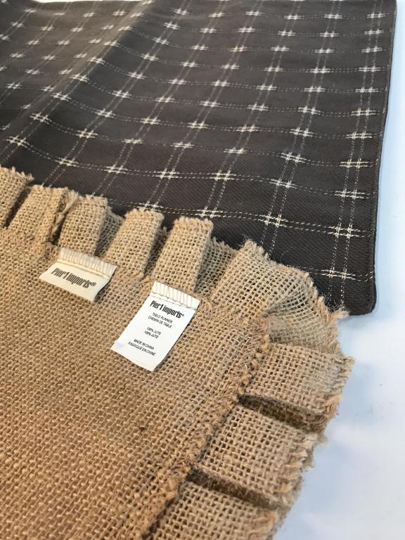 Lot 2 Table Runners: Pier 1 Imports ruffle border jute burlap. Label on cloth. Measures 14.5 x 72 in. approx. Jute is a plant derived fabric that is strong & commonly used to make house goods. Other table runner has a lig