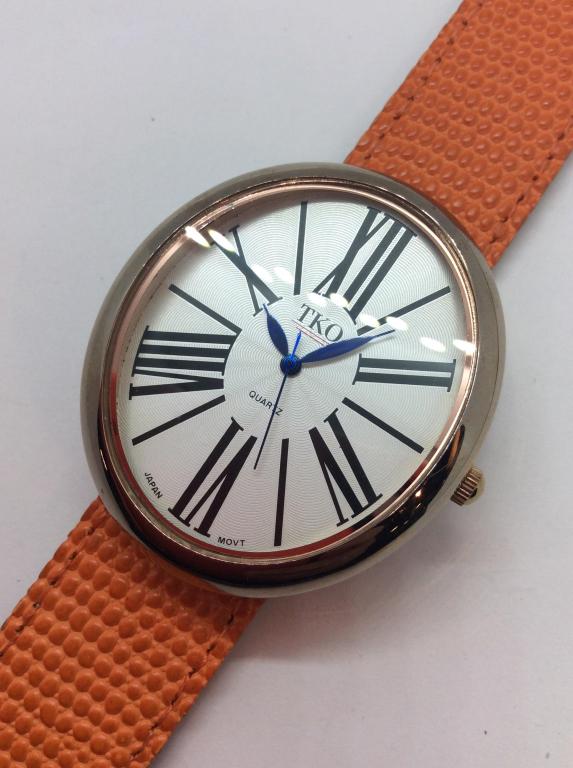 TKO ORLOGI Genuine Leather Band Wristwatch: Orange toned textured band, stamped genuine leather, snap band wristband removable From Watch face, reverse of Watch face reads tko orlogi Stainless Steel Back, front reads TKO, QUARTZ Japan Movt. Mea