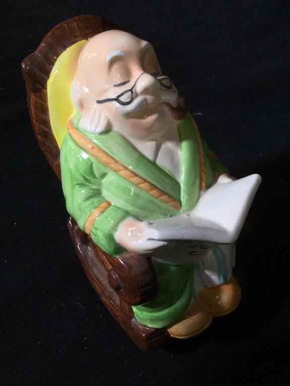Hand painted ceramic Figural coin bank: Figural coinbank Of a man on a rocking chair. Back of book reads retirement fund. Slot on back. Bottom reads lefton china Hand Painted trademark exclusives Korea. 01279. Coin bank, piggy bank, bank, s
