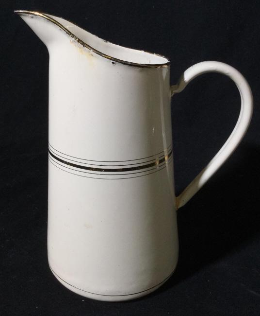 Vintage Drinks pitcher: Made from metal White pitcher with gold tone painted accents. Approximately 9.5 inches tall. Vintage wear. Bottom reads 857. Pitcher, water pitcher,metallic pitcher, vintage pitcher, vessel, decorativ