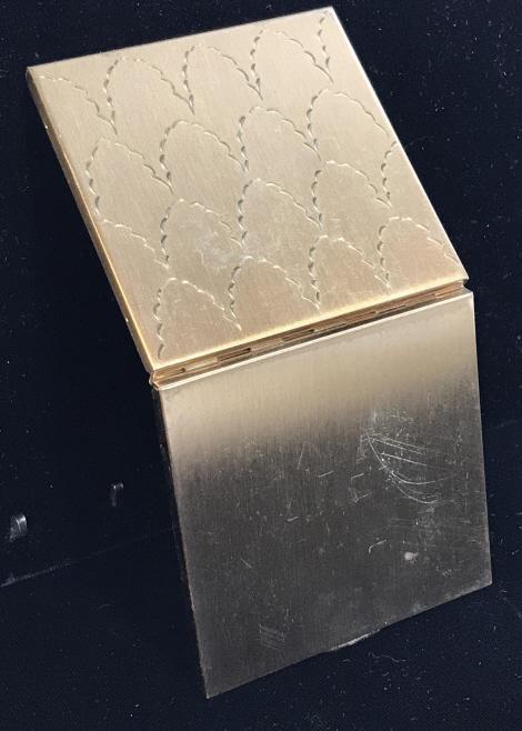 Volupté Gold Toned Metal Compact Mirror, Vintage: Compact has etched Art Nouveau Design On Brushed Gold Tone Metal. Some surface wear. Left over rouge powder. Mirror clear. Measures 2 3/4 x 2 3/4 in. Has felt pouch. Mirror a Compact, Beauty, Cosmetic
