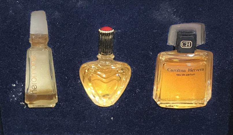 Box of Sample Vintage Designer Perfumes, 3: Carolina Herrera Eau de Parfum, Marilyn Miglin Pherómone, ESCADA Parfum in heart shape bottle. In original box that comes from NEIMAN MARCUS. Three bottles, 2 full (Escada, CH) one has a bit left. Av