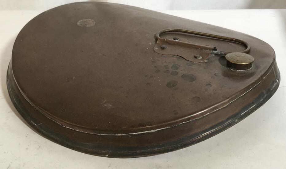 Antique Hot Water Canteen, Bed Warmer- COPPER: Flat disc with handle, cap twists off. Copper Metal. 10 1/4 in diameter. Used to make the bed warm, as a foot warmer, hot water bottle, etc. Added curvature for practical purposes. Antique Hot Water B
