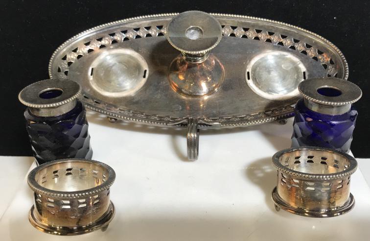 Plated Ink Well & Plume Stand, Tray- England: Vintage. Dual Bottle Ink Well with cobalt blue bottles on either side of pen holder insert. Underside reads Made in England with makers Hallmark. Stirring wand tucks under tray. Footed Tray With finge