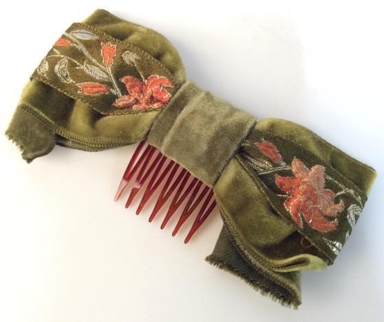Velveteen Fabric Embroidered Hair Accessory: Moss Green Toned velveteen Fabric bow with ribbon with Orange and peach toned floral embroidery, set on hair clip. Measures approx 5 in long. Wearable, fashion accessory, Ladies fashion. 4