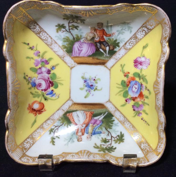Yellow And Gold Toned Porcelain Dish: White Toned porcelain with yellow and gold toned details, floral design and Victorian romantic garden scenes, hallmark on underside with Crown and D. Measures approx 6 in square, Trinket Dish, Candy D