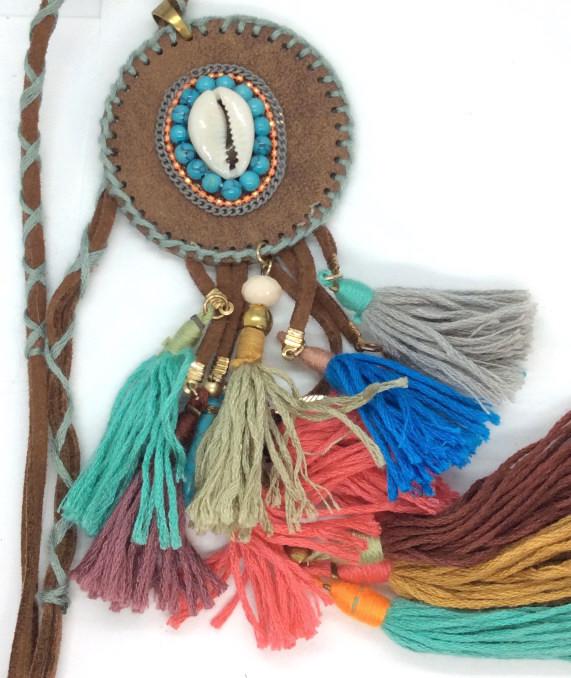 Moon C Paris Shell And Rawhide Necklace: Shell tag reads Moon c Paris, Bright colorful Tassels, brown toned leather material, appears to be rawhide, round rawhide material Pendant with Shell and bead design, hangs approx 21 in. Ladies vintag