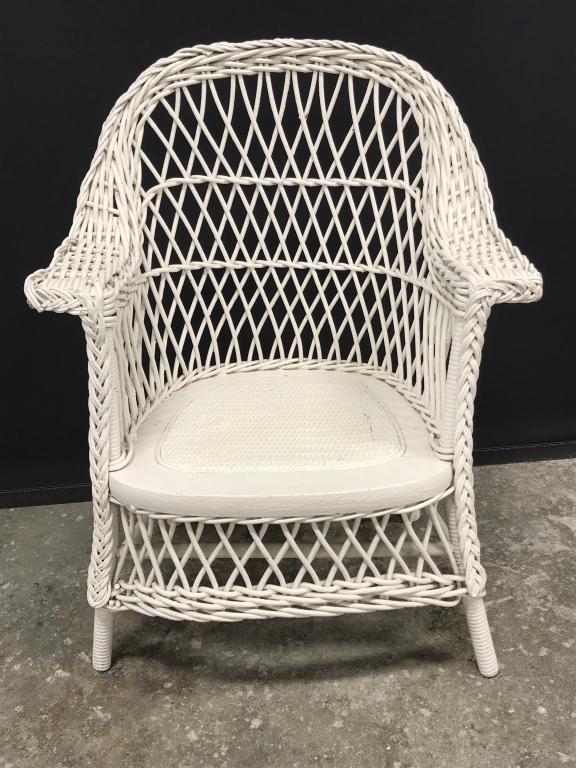 Children’s Painted Wicker Armchair: Armchair is painted white in tone. Measures approx 25 inches in height by 19 inches in width by 12 inches in depth. Some minor surface wear like discoloration in paint. Children’s furniture, armchai
