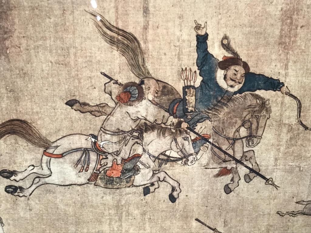 Framed Lithograph, End Of a Mongolian Hunt: Framed lithograph print depciting ‘End Of a Mongolian Hunt,’ with hunters on horseback hunting for deer, rabbits, and rodents. Lithograph is mounted against textured backing and set behind glass i