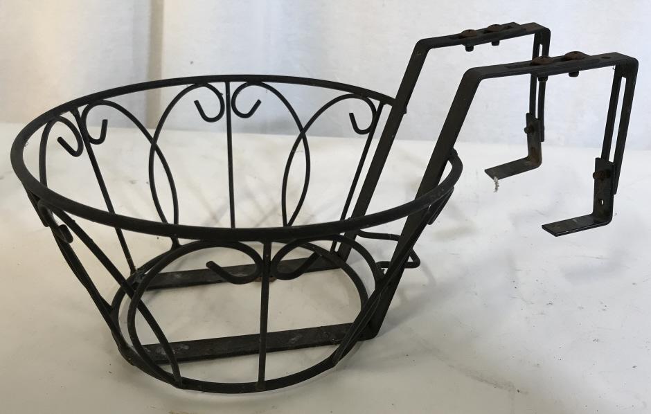Large Metal Railing Planter: Round planter, scroll design, approx 8.5 in. diameter, basket just over 4.5 in. tall. Handle rises less than 1.5 in from top of basket, with 3 in. Width/ depth of whatever it hangs over. Screws have r