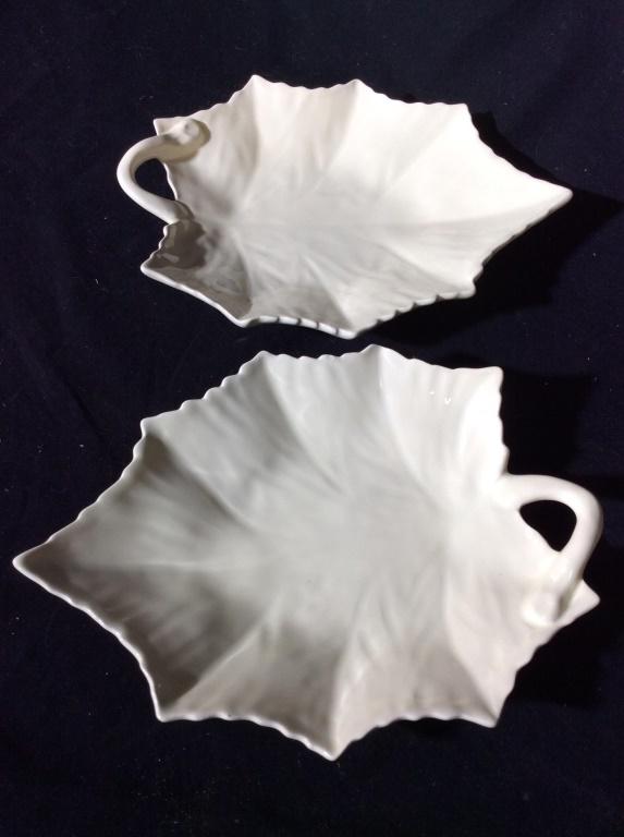Pair BORDALLO PINNEIRO Porcelain Leaf Plates: Lot includes 2 plates. Each have a leaf shape. Both are cream toned. Underside of each reads BORDALLO PINNERO PORTUGAL. Pieces measure approx 10 inches long 7 inches wide. tableware, kitchenware, tabl