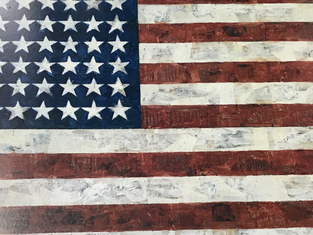 Jasper Johns American Flag Exhibition Poster: Framed Jasper Johns at the Museum Of Modern Art, NY exhibition poster, featuring Johns’ American Flag image. Poster is set behind plexiglass in coated wood frame. Measures approx 31 inches in height