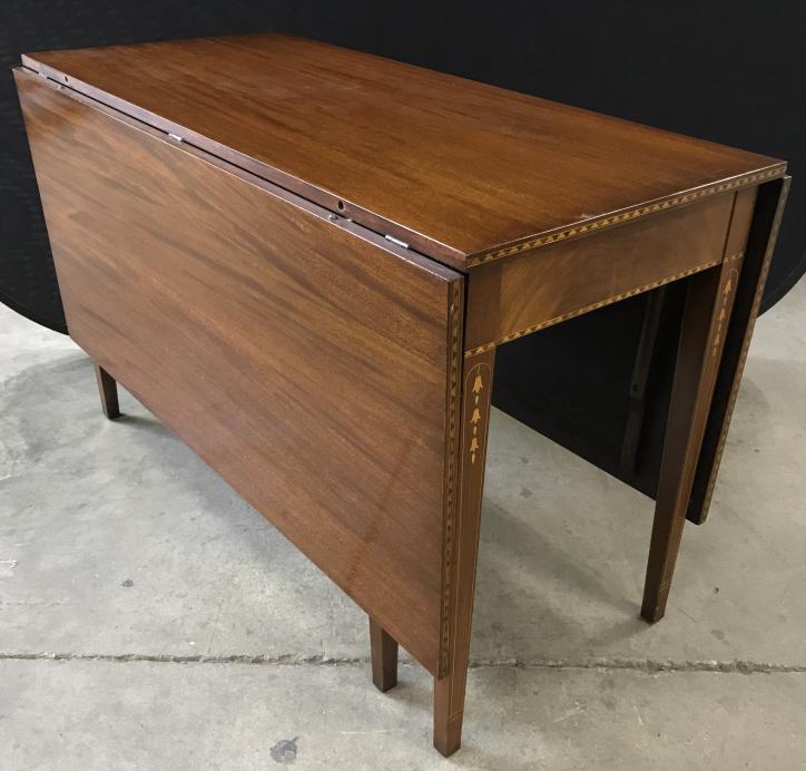 Vintage Drop Leaf Wooden Table With Inlay Design: Vintage Possibly Antique Mahogany Toned Wooden Drop Leaf Table With Inlay Design around base and table edges, some nicks and surface scratches, measures approximately 48 inches long x 23 inches wide x